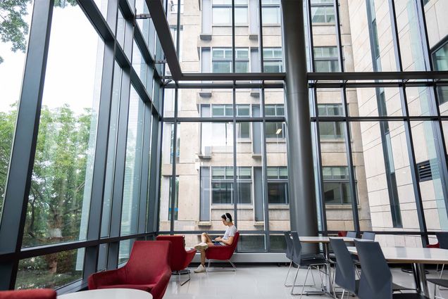 Photo: A student sits, studying quietly in a large empty room at Boston University's LAW building