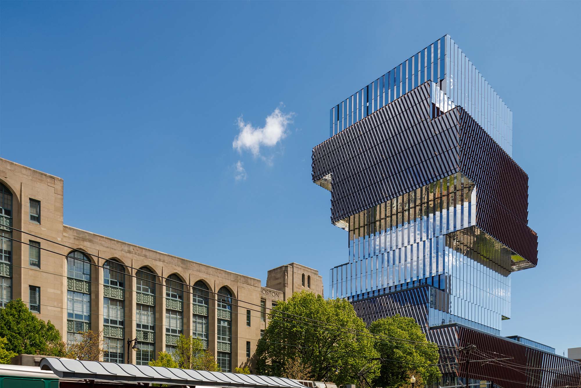 Photo: Exterior shot of BU's Center for Data Sciences, a jenga shaped glass building that stands tall in the Boston Skyline on a sunny day as cars drive by on Commonwealth ave