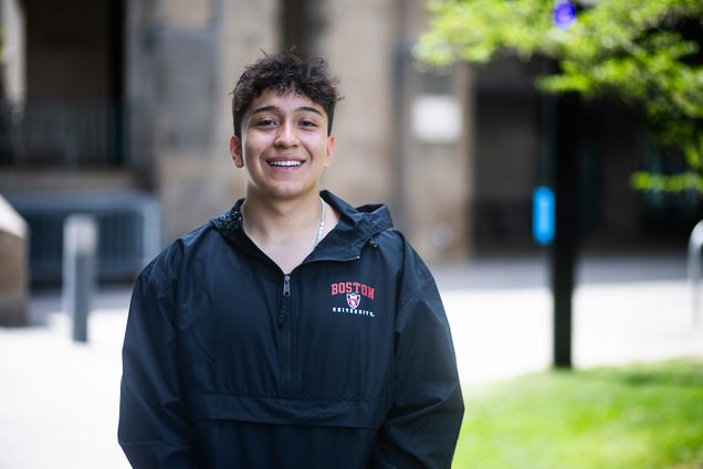 Photo: A picture of a young man wearing a black Boston University windbreaker, with the university's logo at the top left in a red font.