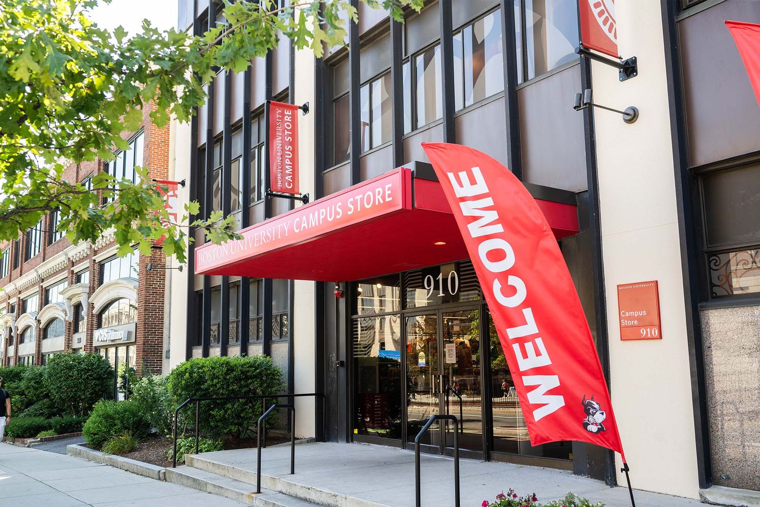 Photo: The Boston University Campus Store, with a large red sign and banner reading "Welcome"