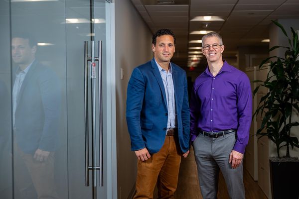 Photo: Michael Alosco, CTE Center codirector and associate professor of neurology, and Thor Stein, associate professor of pathology and laboratory medicine. Alosco wears a blue blazer and tan pants while Stein wears a purple shirt and gray pants.