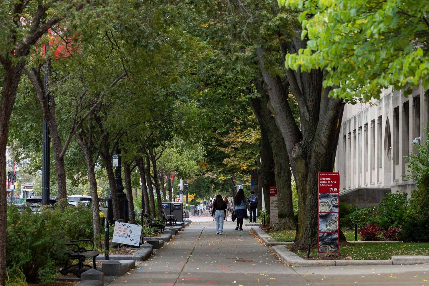 Photo: Students stroll down Comm Ave on Boston University's campus on a sunny day