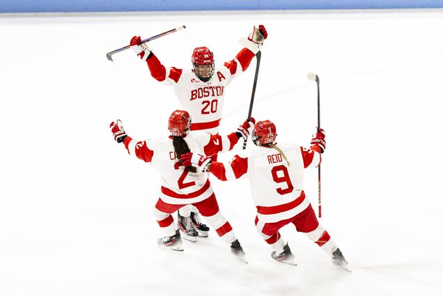 Photo: Three female hockey players in Boston University uniforms celebrating on the ice