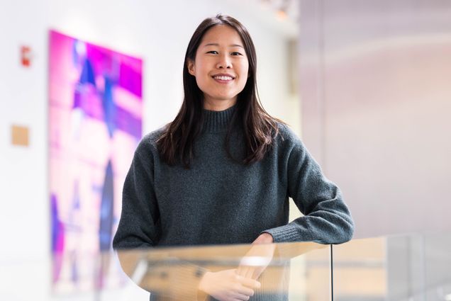 Photo: CAS professor Lynne Chantranupong, a young Asian woman wearing a grey sweater, poses for a photo