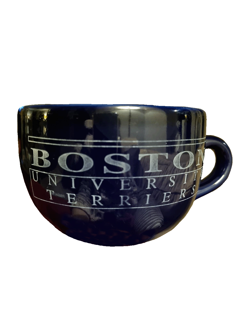 Photo: A stout, shiny black mug with the words "Boston University Terriers" printed on the front in faded white letters.