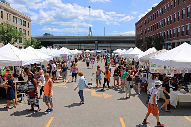 Photo: A picture of the SoWa Open Market, a parking lot that is full of white tents selling food, art, and trinkets