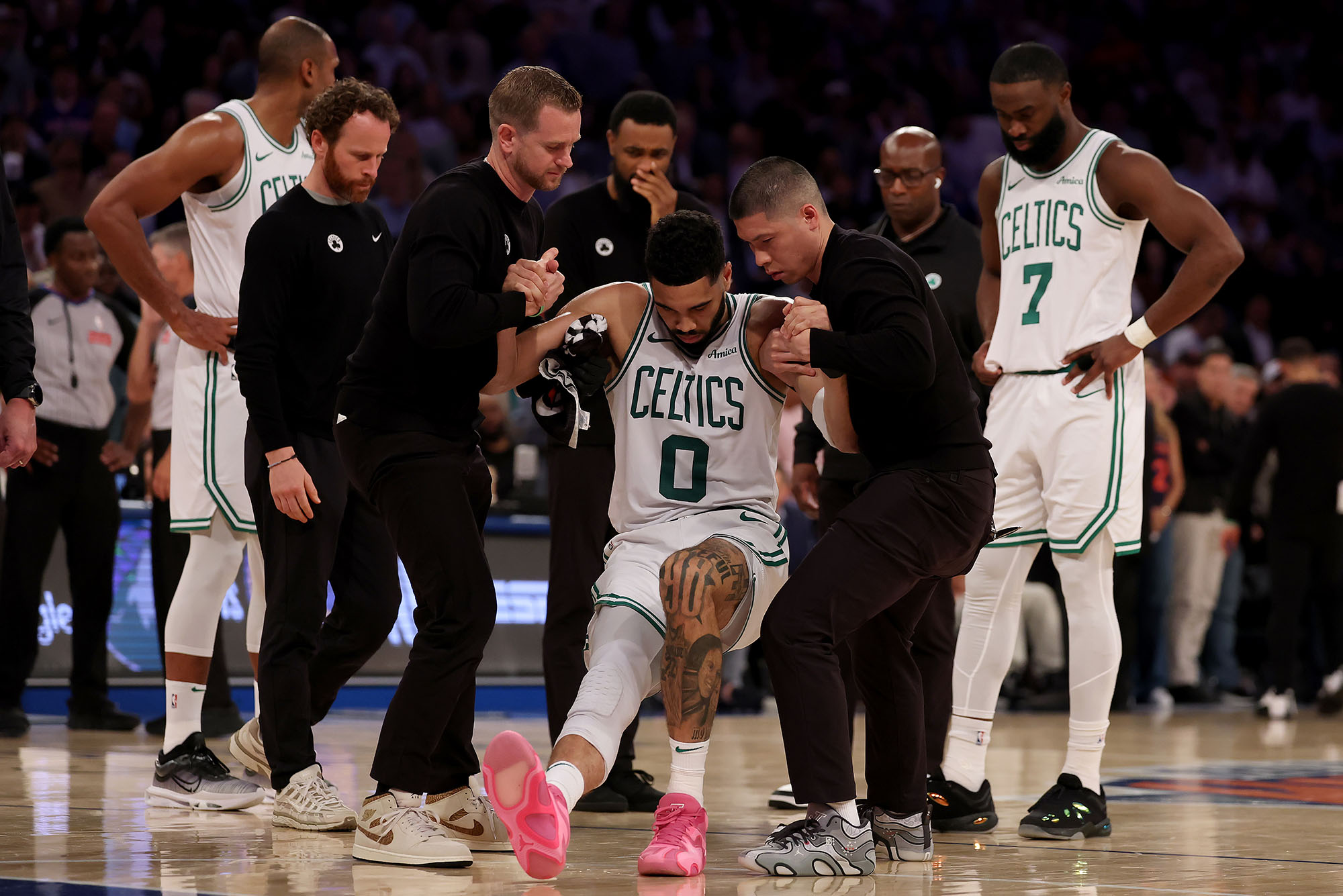 Photo: Jayson Tatum of the Boston Celtics is assisted off the court after an injury at Madison Square Garden