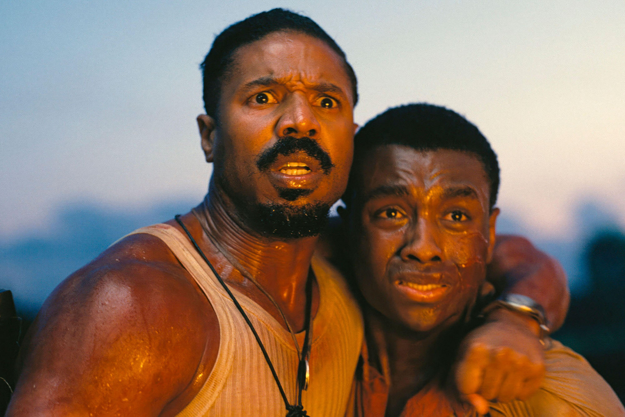 Photo: A still from the movie "Sinners" with two men looking off into the distance afraid