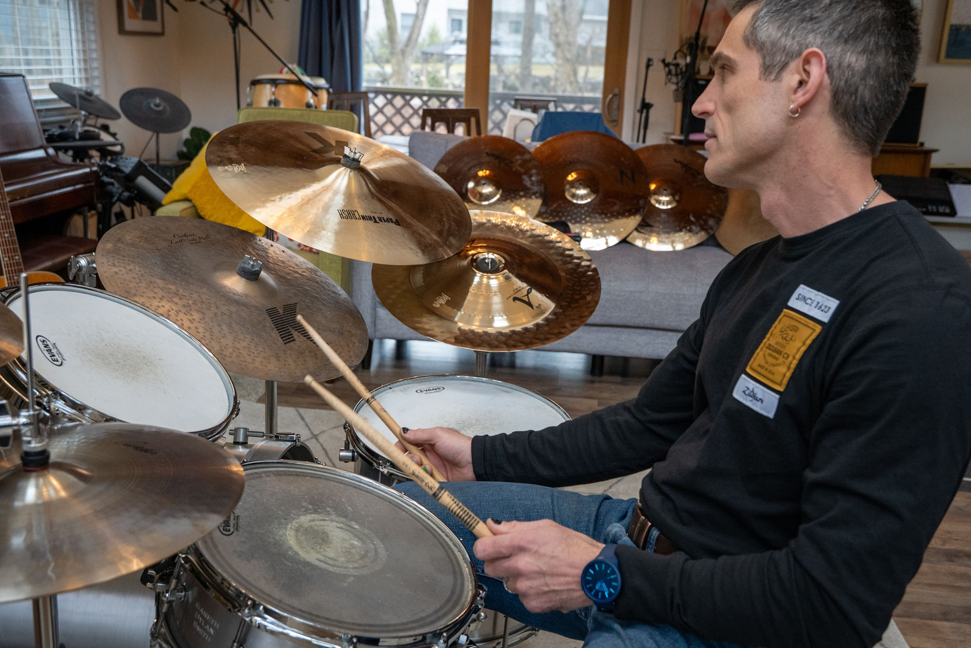 Photo: A man sitting behind a drum kit and playing