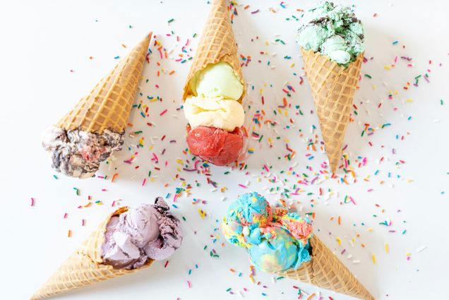 Photo: Stock image of five different ice cream waffle cones artistically laid about with various rainbow sprinkles in between.