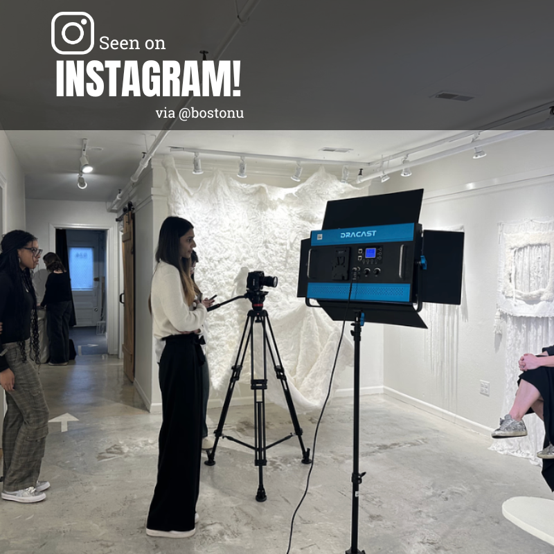 Photo: A lone person manning a camera in an all white studio space.