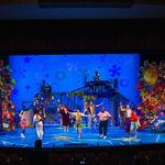 Photo: A wide shot of the stage during the Wheelock Family Theatre's production of "The Spongebob Musical." The set features lots of blues, to simulate being underwater, and the actors are in colorful attire. Along the side of the stage is colorful stacks of memorabilia