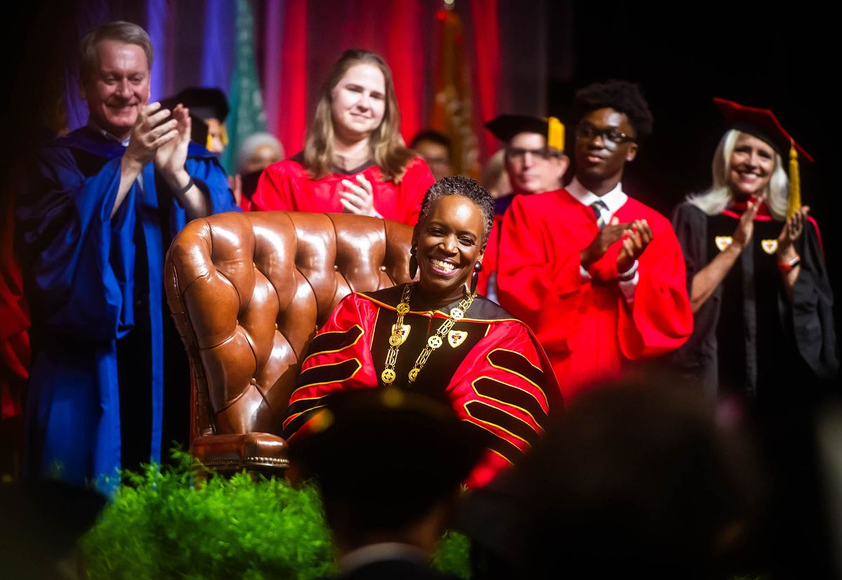 Photo: Melissa L. Gilliam sits in the leather chair that belonged to one of BU’s founders, Isaac Rich. The chair was used in 1869 when a petition was signed to charter BU as a new corporation.