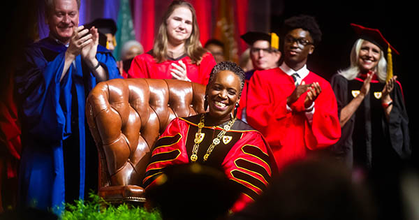 Photo: Melissa L. Gilliam sits in the leather chair that belonged to one of BU’s founders, Isaac Rich. The chair was used in 1869 when a petition was signed to charter BU as a new corporation.