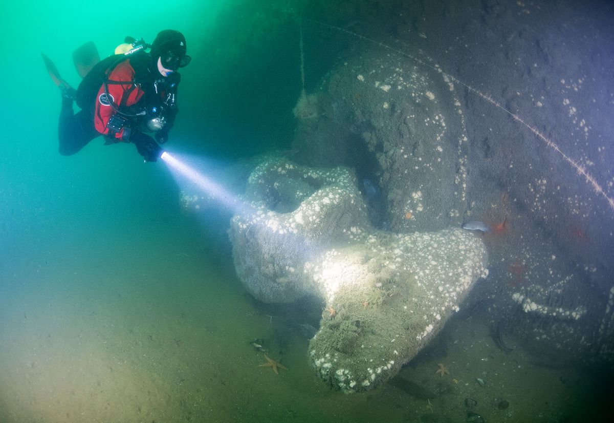 Photo: An underwater shot of diver Jennifer Sellitti illuminates an anchor from the USS San Diego, a US Navy armored cruiser that sank off the coast of Long Island in 1918