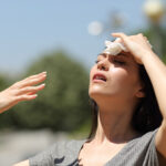 Photo: Asian woman drying sweat in a warm summer day