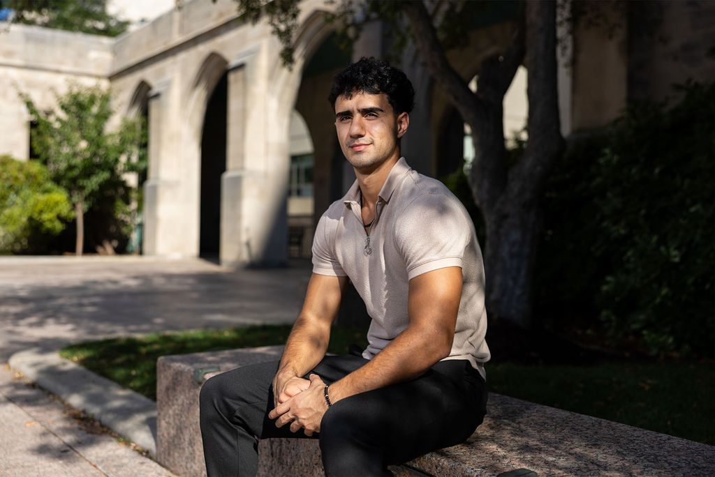 Photo: A young man with short dark hair poses for a serious formal headshot