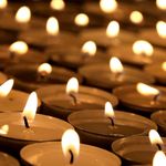 Photo: a large sea of tea lights at a candlelight vigil