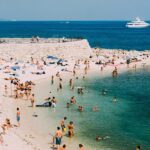 Photo: A picture of a crowded beach with many people swimming