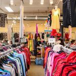 Racks of colorful clothing on display in Goodwill