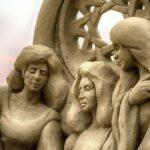 Photo: A picture of a sand castle sculpture featuring three women