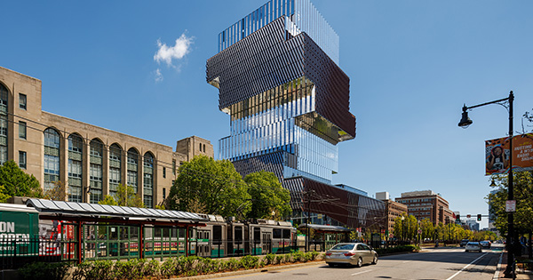 Photo: Exterior shot of BU's Center for Data Sciences, a jenga shaped glass building that stands tall in the Boston Skyline on a sunny day as cars drive by on Commonwealth ave