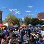 Photo: A snapshot people mingling on a street with vendors surrounding them.