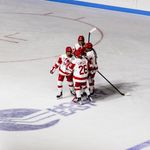 Photo: BU Women's Hockey players celebrating on the ice