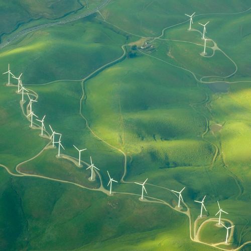 Rolling green hills with wind turbines