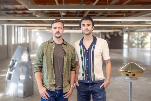 Two men from Inversion Space standing in their workspace