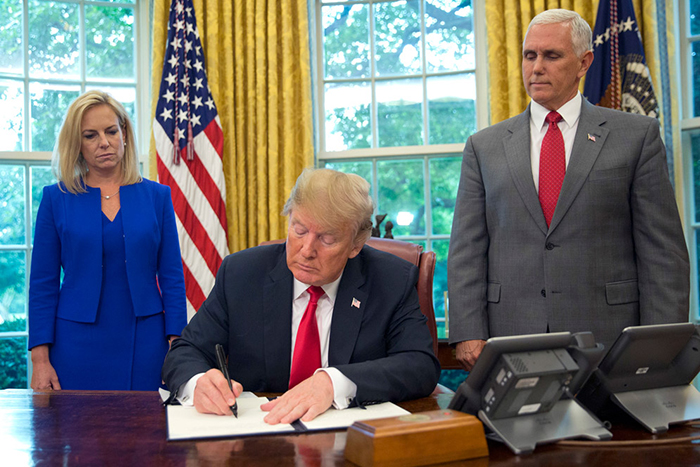 President Trump signing an executive order on immigration