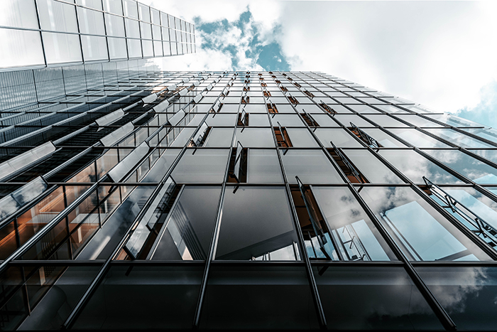 Low-angle photo of curtain glass wall building, photo by Christian Wiediger