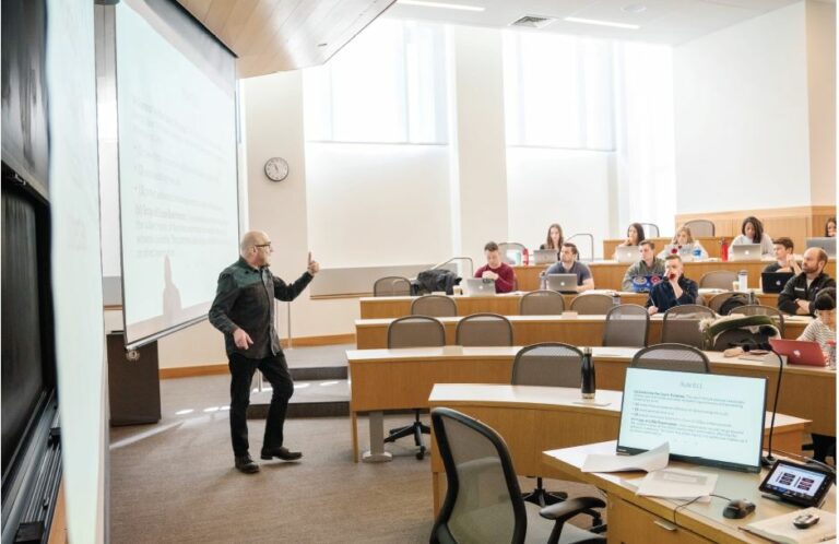 Donweber Teaching in a lecture hall far left