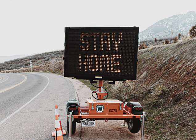 Road sign with the message "stay home" on it