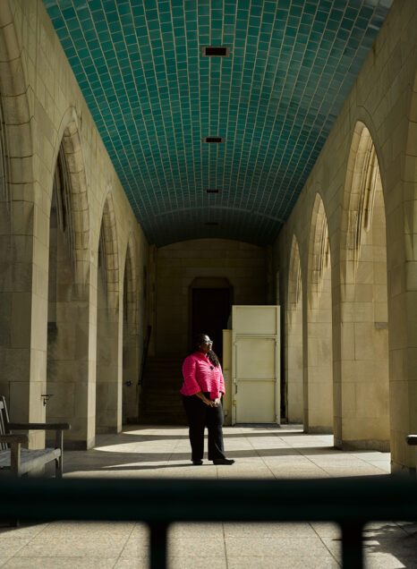 Dean Angela Onwuachi-Willig stands under stone archway in BU's Marsh Plaza