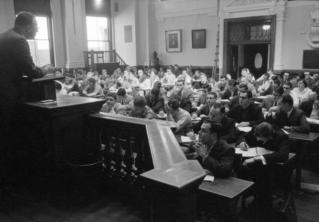 A black and white photo from 1958 of Dean Hettrick teaching a class at 11 Ashburton Place, Boston
