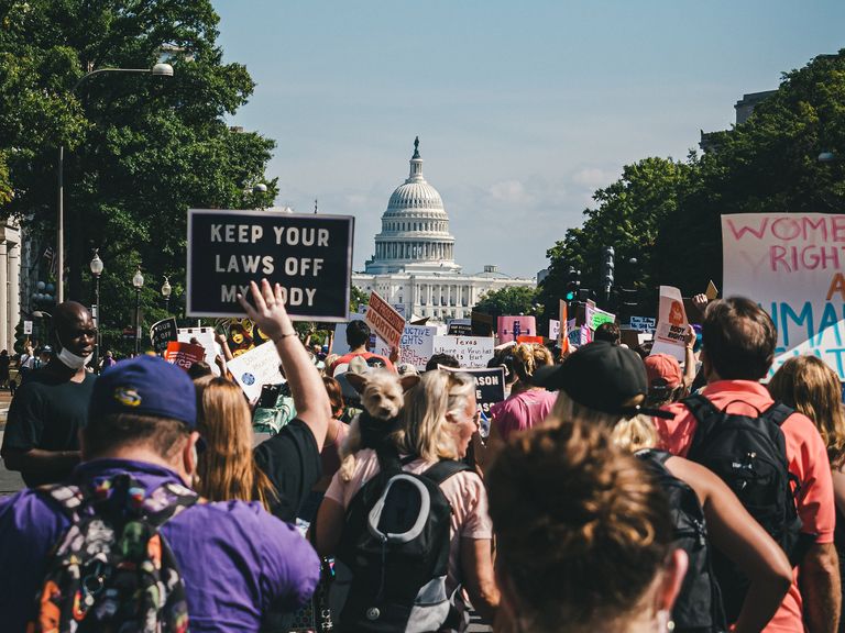 A large group of reproductive rights protestors approach the US Capitol building