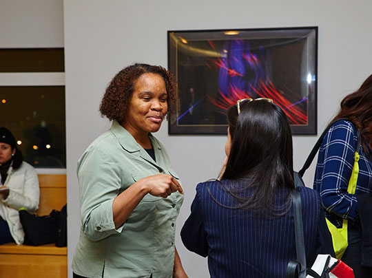 Two people having a conversation at a career networking event.