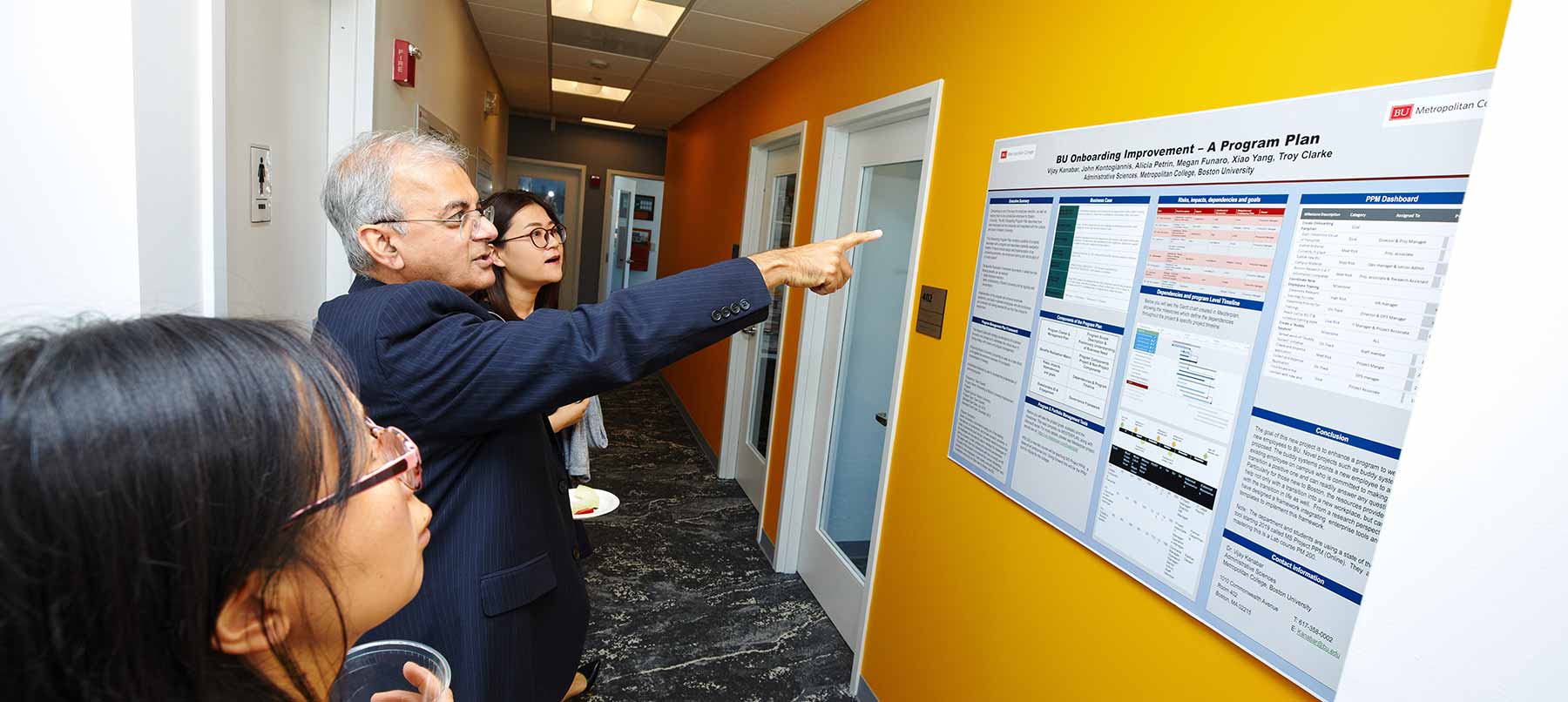 MET Professor Vijay Kanabar presenting a poster titled "BU Onboarding Improvement - A Program Plan