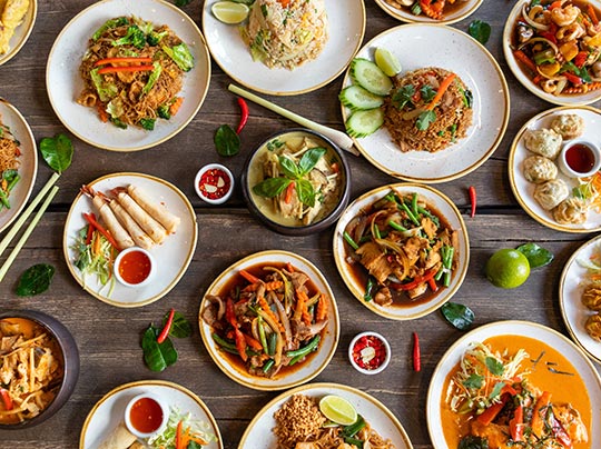 Various Thai food dishes spread across a table