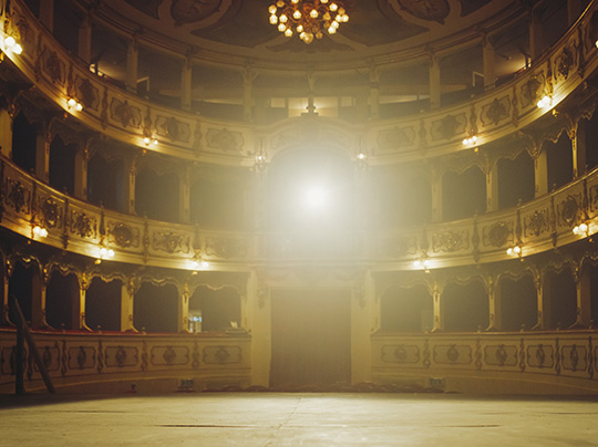 Wide shot of an elegant classic theatre with spotlight shot from the stage