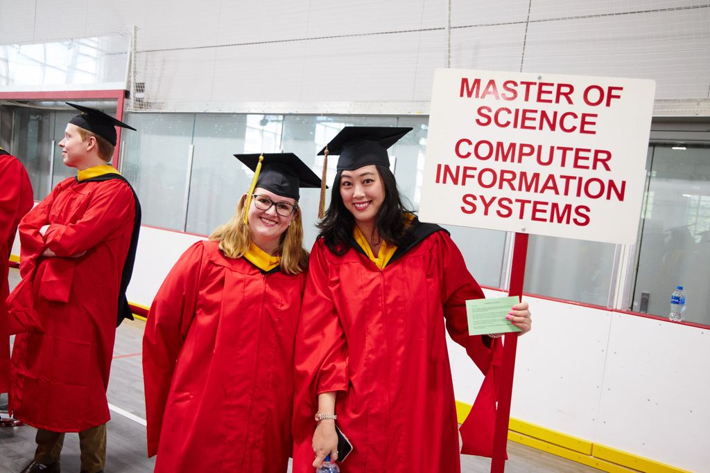 Two graduates at BU MET Commencement