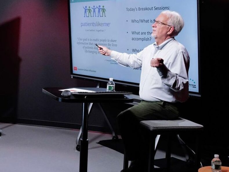 Professor lectures to an online class in a studio