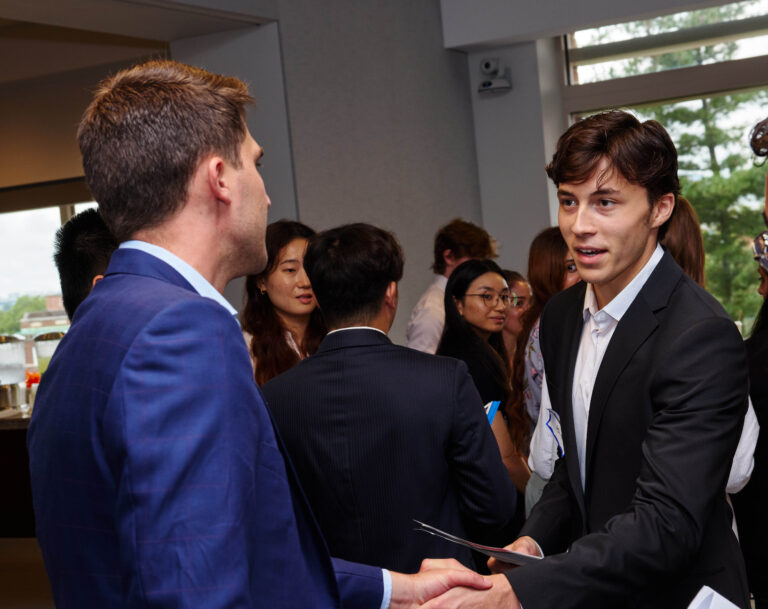 Students and alumni meeting at an event