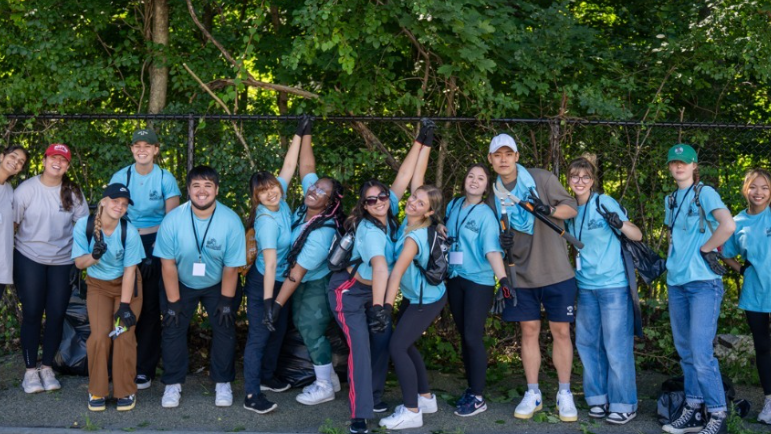 Several undergrad volunteers pose outside