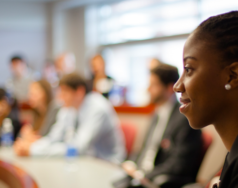 Graduate student in class listening to lecture