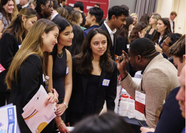 Students listening to a potential employer at a career fair