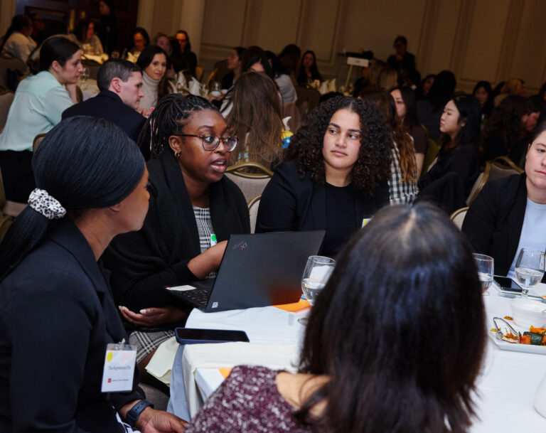 Several women students speak at a round table