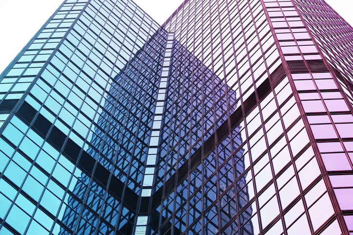 Interesting reflection and lines formed by two modern glass architecture