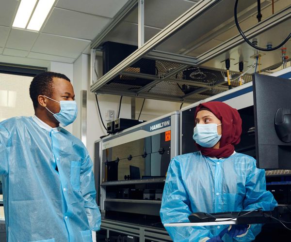 Two researchers interacting in lab